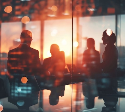 Indistinct group of people in a room with backlighting
